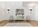 Modern entryway with hardwood floors, a console table, and two accent chairs at 213 Westhampton Dr, Pittsboro, NC 27312