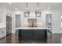 Modern kitchen with white cabinets, large island, and stainless steel appliances at 13629 Old Creedmoor Rd, Wake Forest, NC 27587