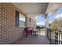 Relaxing side porch with a wicker chair and countryside view at 607 Dycus Rd, Sanford, NC 27330
