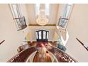 Impressive two-story foyer with a grand staircase and chandelier at 40002 Worth, Chapel Hill, NC 27517