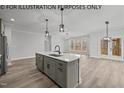 Open concept kitchen with island, gray cabinets, and breakfast area at 622 Sherron Rd, Durham, NC 27703