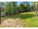 Spacious backyard with lush green grass, providing ample space for outdoor activities at 104 Cochise Dr, Louisburg, NC 27549