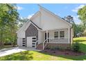 Modern house with stone accents and a two-car garage at 104 Cochise Dr, Louisburg, NC 27549