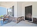 Front porch with rocking chairs and a black front door at 822 Biltmore, Sanford, NC 27332