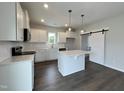 Modern kitchen with white cabinets, quartz countertops, and stainless steel appliances at 40 Longbow Dr, Middlesex, NC 27557