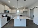 Modern kitchen with white cabinets, quartz countertops, and stainless steel appliances at 40 Longbow Dr, Middlesex, NC 27557