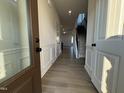 Bright entryway with hardwood floors and an open view to the stairs and living room at 116 Commons Cir # 229, Clayton, NC 27520