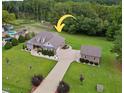 Aerial view of a house with a detached garage and large backyard at 1296 Rawls Church Rd, Angier, NC 27501