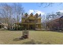 Two story home with large front porch and yellow siding at 283 Old Christian Chapel Rd, New Hill, NC 27562