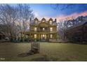 Two story home with large front porch and yellow siding at dusk at 283 Old Christian Chapel Rd, New Hill, NC 27562