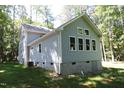 Two-story house with gray siding, deck, and backyard at 7647 Cummings Dr, Mebane, NC 27302