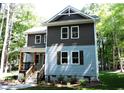 Two-story house with gray and brown siding, front porch and stairs at 7647 Cummings Dr, Mebane, NC 27302