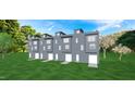 Modern gray townhome exterior with attached garage and landscaped lawn at 801 Martin Luther King Jr Blvd # D, Raleigh, NC 27601