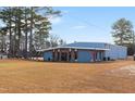 Metal building with a red door and large windows at 124 Don Ron Rd, Erwin, NC 28339