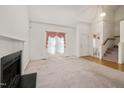 Living room with hardwood floors, fireplace, and access to half bathroom at 424 Mountain Lake Dr, Raleigh, NC 27610