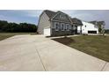 New construction home with large concrete driveway at 103 Sage Ln # 009, Four Oaks, NC 27524