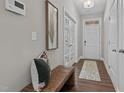 Bright foyer with a bench, wood floors, and French doors at 305 Sutherland Dr, Franklinton, NC 27525
