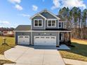 Two-story home with gray siding, white trim, and a two-car garage at 345 Sutherland Dr, Franklinton, NC 27525