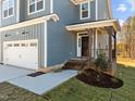 Front entrance with brick steps and a covered porch at 345 Sutherland Dr, Franklinton, NC 27525