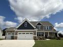 Two-story home with three car garage and landscaping at 234 Crystal Springs Way, Benson, NC 27504