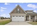 Two-story house with a two-car garage and a gabled roof at 71 Hillwood Dr, Sanford, NC 27332