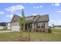 Two-story house with neutral siding and a tree in front at 71 Hillwood Dr, Sanford, NC 27332