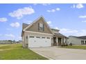 Two-story house with a two-car garage and stone accents at 71 Hillwood Dr, Sanford, NC 27332