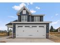 Two-story house with gray siding, white trim, and a two-car garage at 109 Hillwood Dr, Sanford, NC 27332