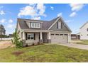 House exterior featuring beige siding and a two-car garage at 127 Hillwood Dr, Sanford, NC 27332