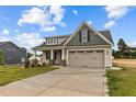House exterior featuring beige siding and a two-car garage at 127 Hillwood Dr, Sanford, NC 27332