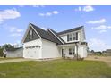 Two-story house with white siding, gray roof, and a two-car garage at 53 Hillwood Dr, Sanford, NC 27332