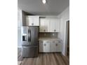 Stainless steel refrigerator and white cabinets highlight this kitchen at 1031 Westerland Way # 46, Durham, NC 27703