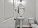Clean powder room with pedestal sink and toilet at 188 Hillwood Dr, Sanford, NC 27332