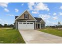 House with a two-car garage and gray siding, on a grassy lot at 152 Hillwood Dr, Sanford, NC 27332