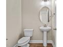 Small bathroom with pedestal sink and toilet at 147 Hillwood Dr, Sanford, NC 27332
