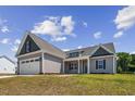 House exterior, two-car garage, landscaping, front walkway at 50 Oleander Ln, Sanford, NC 27332