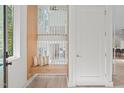 Light-filled entryway with built-in bench and view of upper level at 1435 Duplin Rd, Raleigh, NC 27607