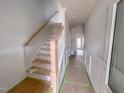 Wooden staircase with simple railing in a new home at 125 Sugar Run Dr # 26, Fuquay Varina, NC 27526