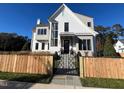 Inviting front yard with a wooden picket fence and a decorative metal gate at 3401 Makers Cir, Raleigh, NC 27612