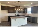 Modern kitchen with stainless steel appliances and an island at 323 Chestnut Oak Ln, Lillington, NC 27546