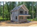 Two-story house with light brown siding, dark brown accents, and a front porch at 204 Cardinal Ct, Oxford, NC 27565