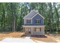 Two-story house with gray and blue siding, front porch and landscaping at 206 Cardinal Ct, Oxford, NC 27565