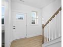 Clean entryway with white door and wooden floors at 329 Roxboro St, Haw River, NC 27258