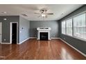 Spacious living room with hardwood floors, fireplace and ceiling fan at 1331 Still Monument Way, Raleigh, NC 27603