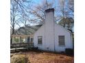 Side view of a white house with a sunroom and multiple windows at 1852 Nc 62 Hwy N, Burlington, NC 27217