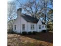 Exterior view of a white single-story home with visible AC unit at 1852 Nc 62 Hwy N, Burlington, NC 27217