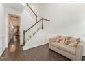 Bright entryway with staircase, hardwood floors, and a small sofa at 1121 Talisker Way, Burlington, NC 27215
