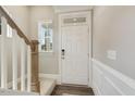 Inviting entryway with staircase, wood flooring, and a coat closet at 3455 Piedmont Dr, Raleigh, NC 27604