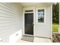 Modern dark-stained front door with sidelight window at 3455 Piedmont Dr, Raleigh, NC 27604