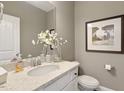 Stylish powder room with white vanity and granite countertop at 3455 Piedmont Dr, Raleigh, NC 27604